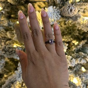 Sterling silver ring with a beautiful large purple stone centerpiece.